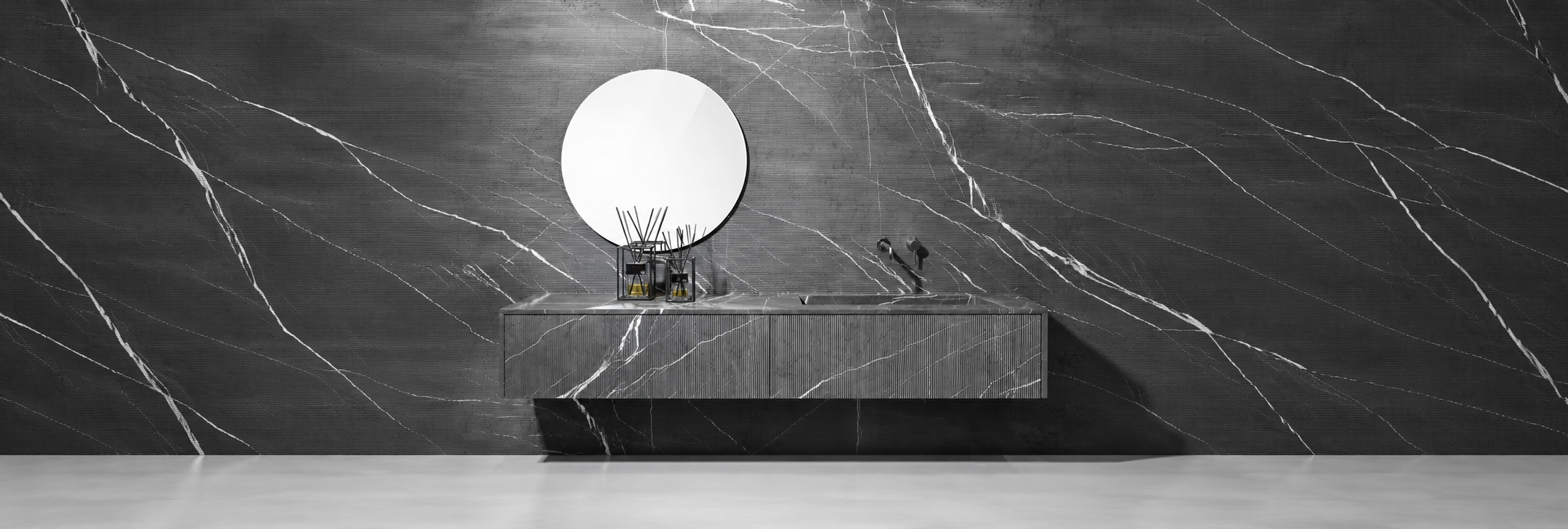 Dark natural stone bathroom vanity with a round mirror